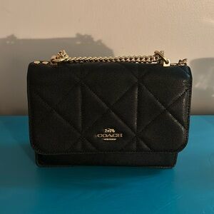 Black and gold crossbody Coach purse